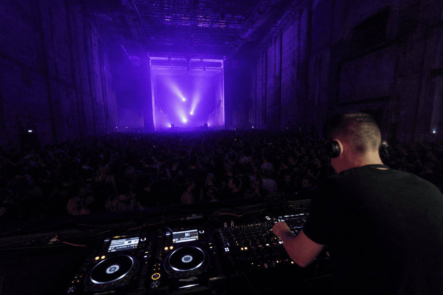 Jordan Vale performing a live electronic set in a dark club